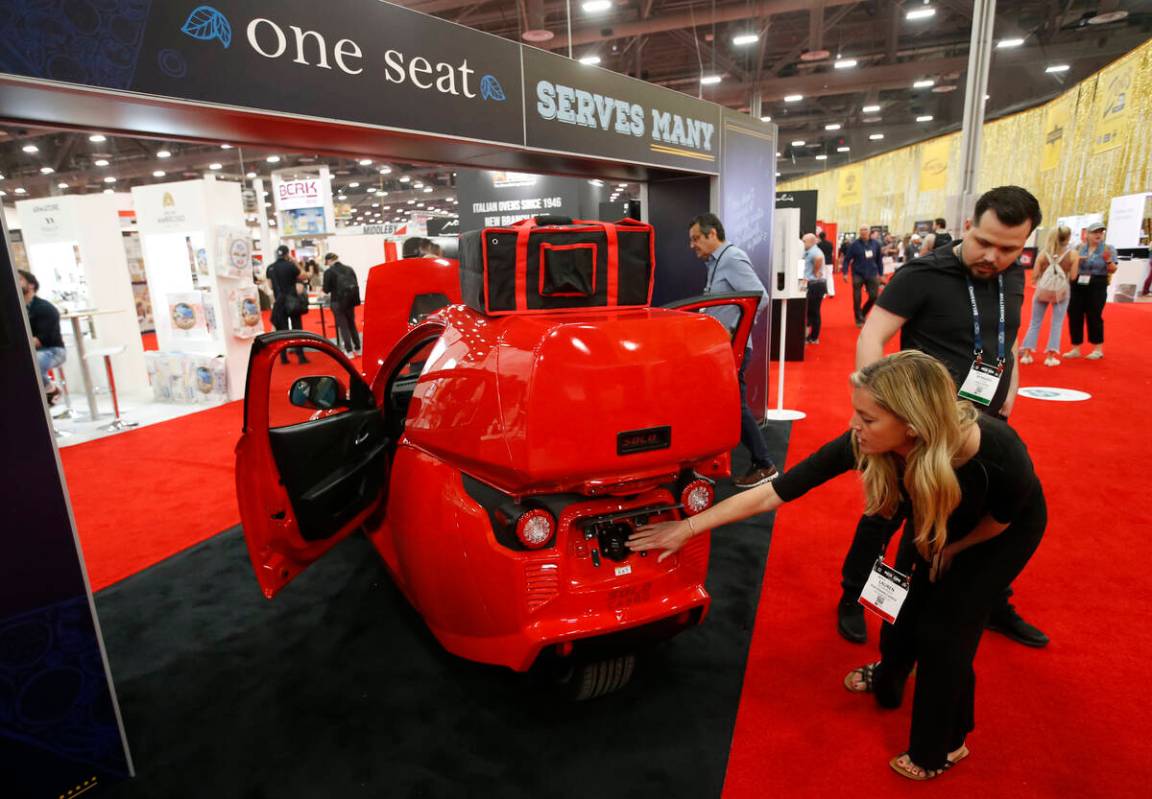 Lauren Iacoangelo, of ElectraMeccanica, points out to the charging port of the Solo electric ve ...