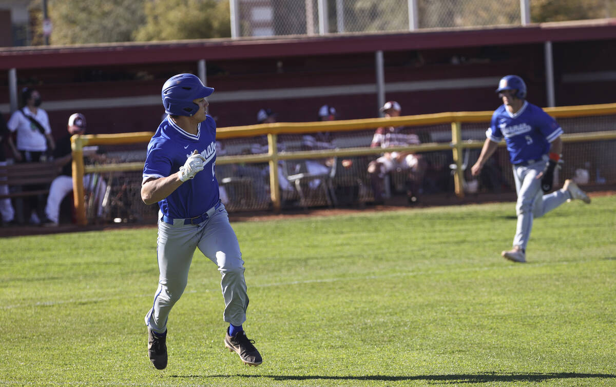 Bishop Gorman first baseman Tai Nguyen (17) runs to first base as shortstop/pitcher Demitri Dia ...