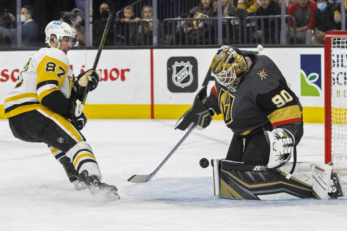 Golden Knights goaltender Robin Lehner (90) makes a save against Pittsburgh Penguins center Sid ...