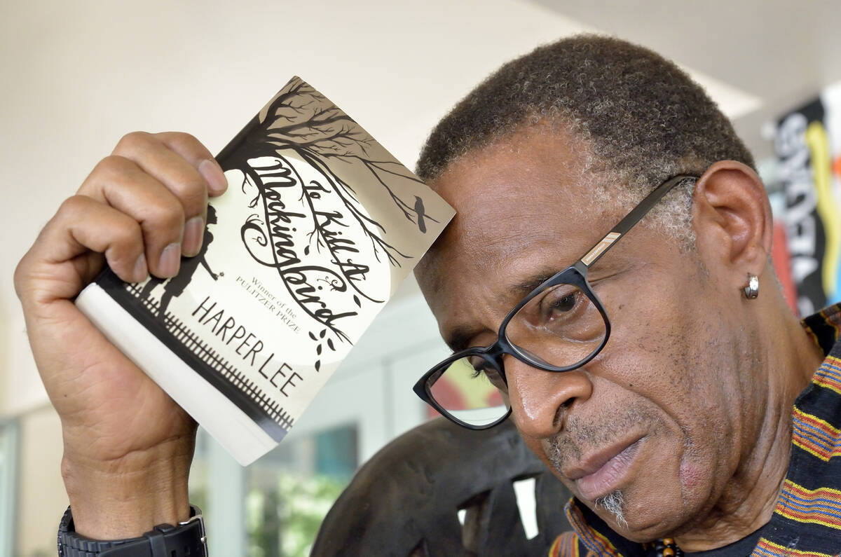 Actor and teacher Antonio Fargas is shown with a copy of Harper Lee's "To Kill a Mockingbird" a ...