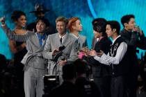 BTS accepts the award for favorite pop song for "Butter" at the American Music Awards ...