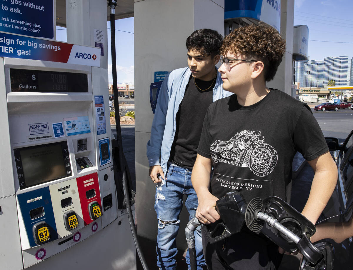 Gilberto Gonzalez, left, and his friend Naim Garcia, both of Las Vegas check out the price of g ...