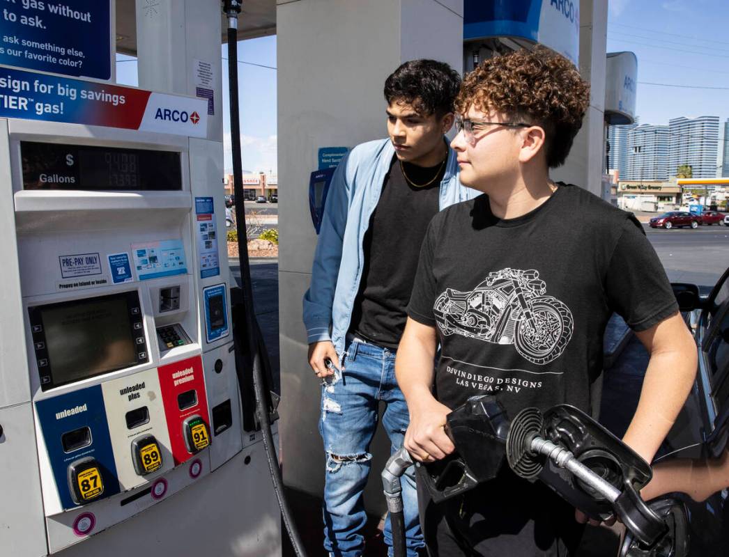 Gilberto Gonzalez, left, and his friend Naim Garcia, both of Las Vegas check out the price of g ...