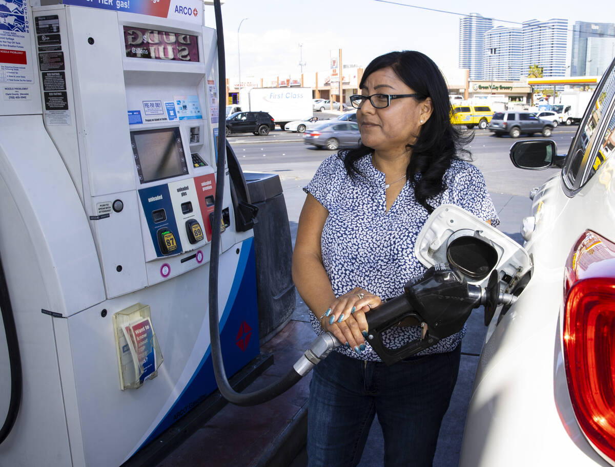 Rosa Aguirre of California pumps gas at ARCO gas station on Tropicana Avenue on Tuesday, March ...