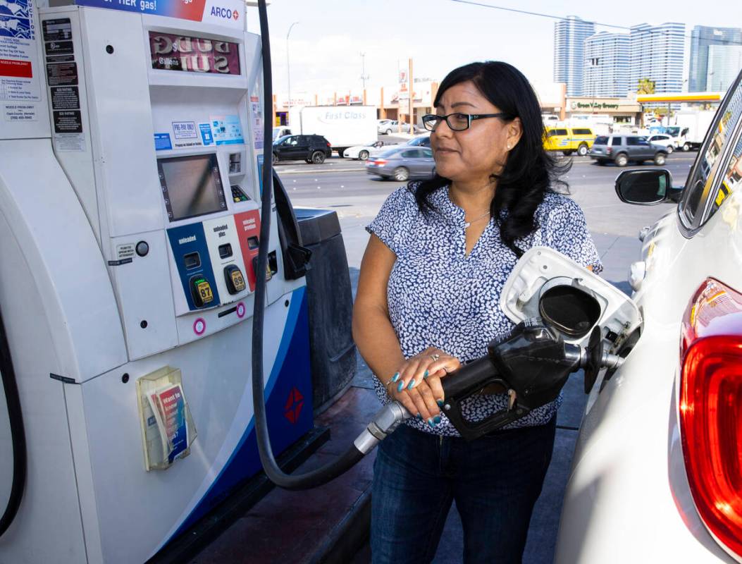 Rosa Aguirre of California pumps gas at ARCO gas station on Tropicana Avenue on Tuesday, March ...