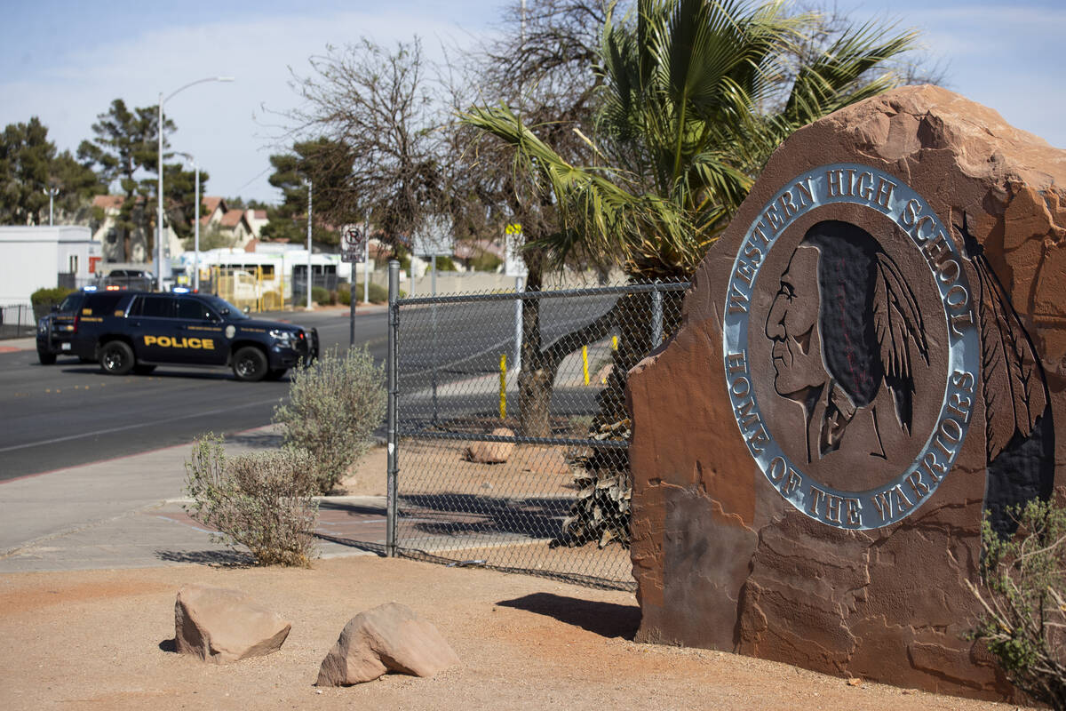 Police investigate a shooting at Western High School in Las Vegas, Tuesday, March 29, 2022. (Er ...