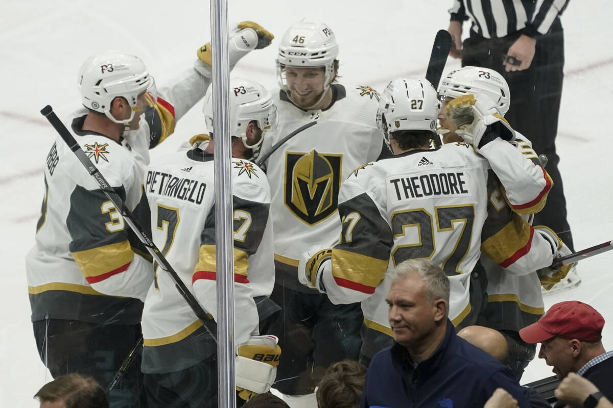 Vegas Golden Knights defenseman Shea Theodore (27) is greeted by teammates after he scored a go ...
