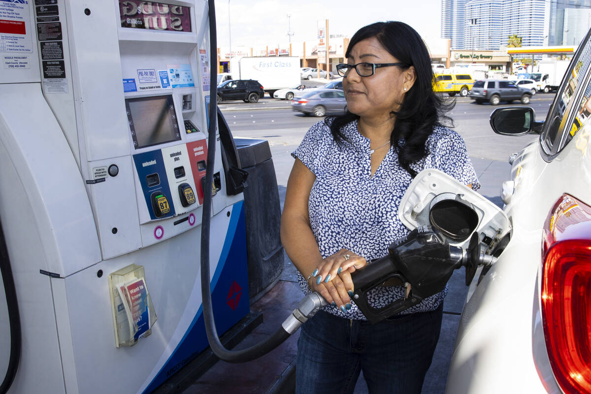 Rosa Aguirre of California pumps gas at ARCO gas station on Tropicana Avenue on Tuesday, March ...