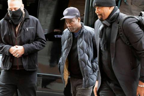 Chris Rock, center, arrives at the Wilbur Theater before a performance, Wednesday, March 30, 20 ...