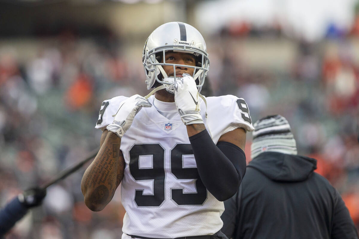 Raiders defensive end Clelin Ferrell (99) warms up on the field before an NFL playoff game agai ...