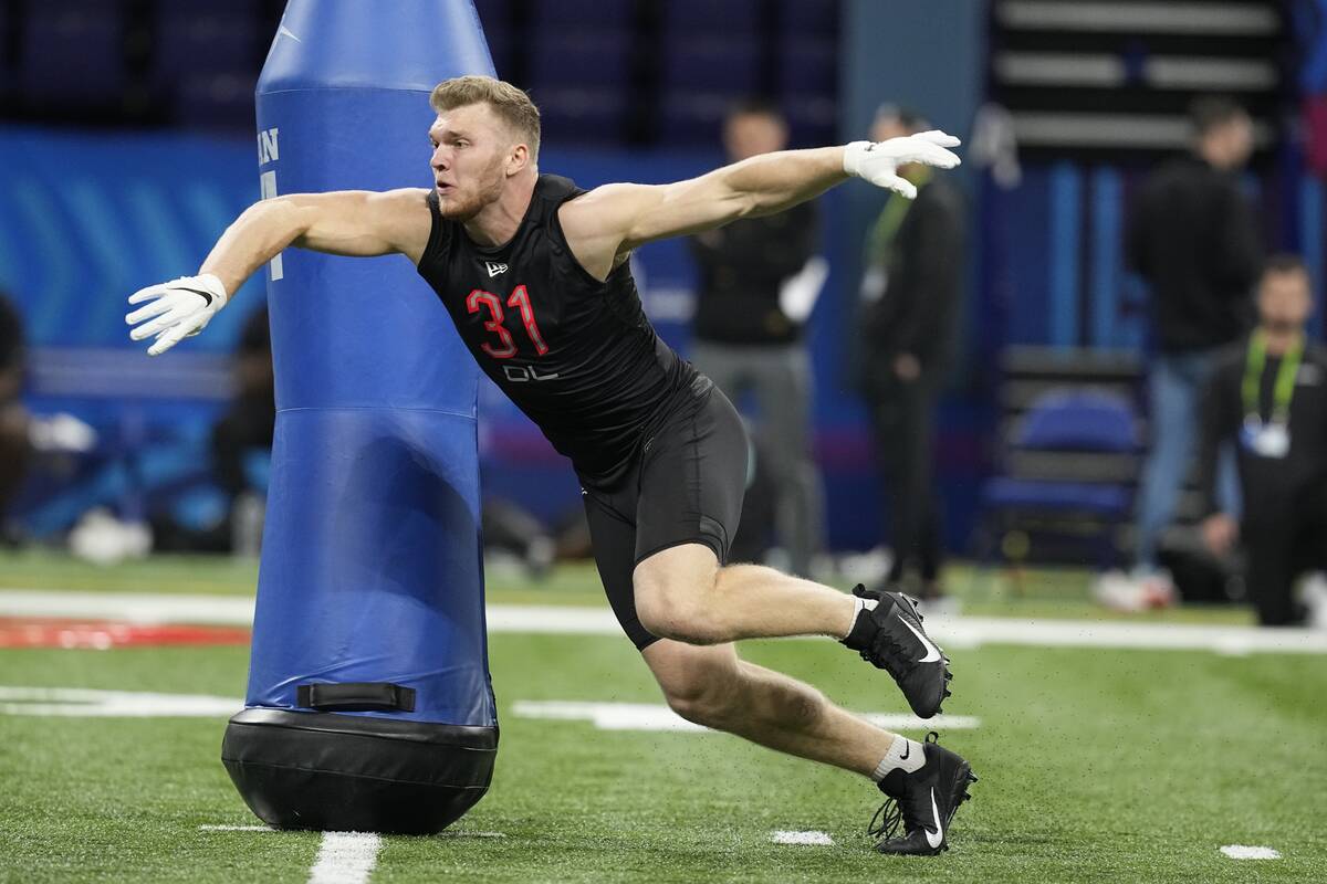 Michigan defensive lineman Aidan Hutchinson runs a drill during the NFL football scouting combi ...