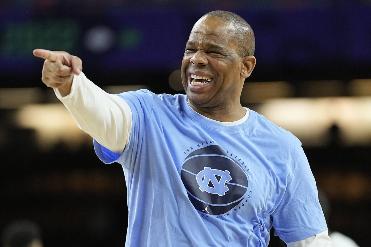 North Carolina head coach Hubert Davis points during practice for the men's Final Four NCAA col ...