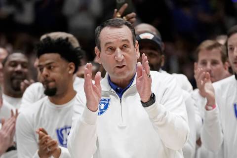 Duke coach Mike Krzyzewski applauds while being recognized prior to the team's NCAA college bas ...