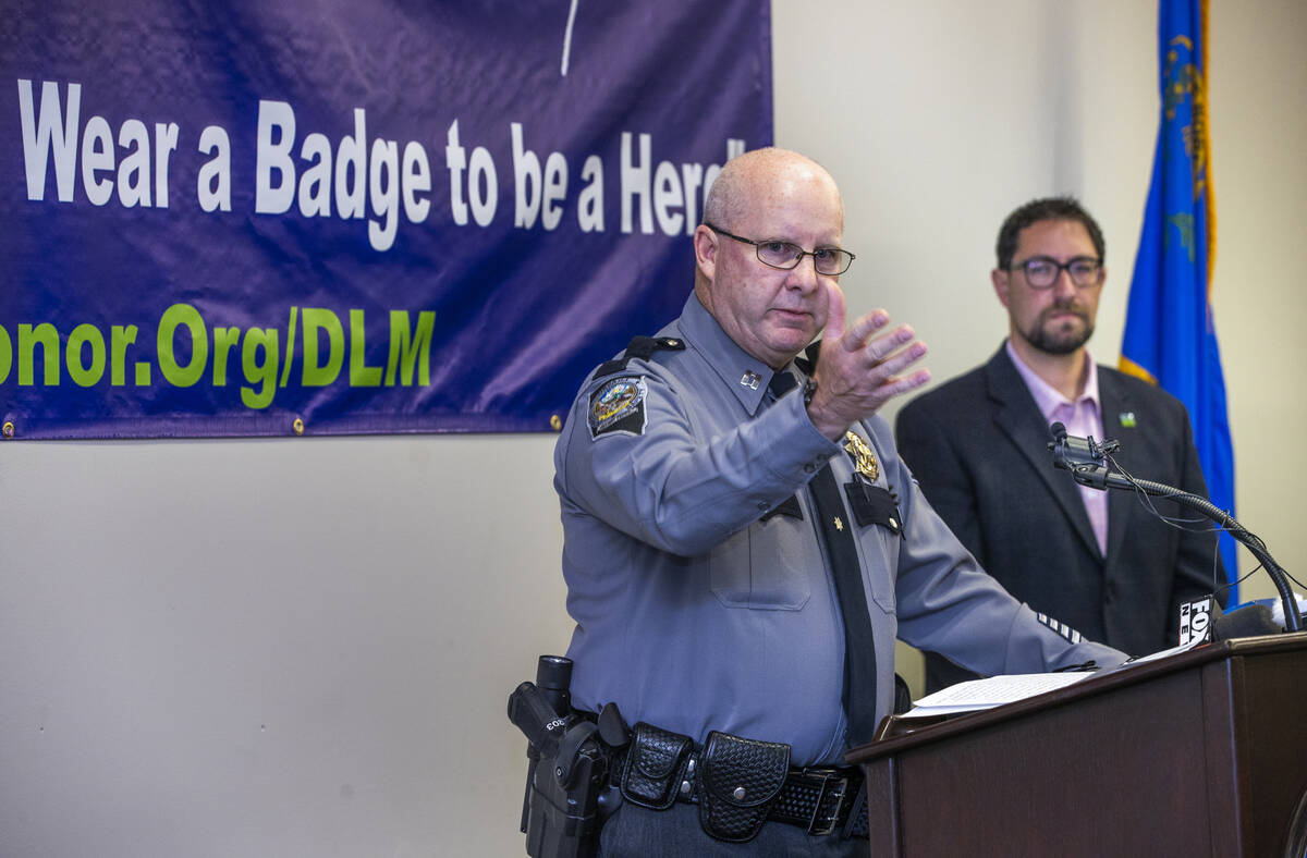 Nevada Highway Patrol Capt. Kevin Honea, left, speaks beside Clark County Commissioner Michael ...