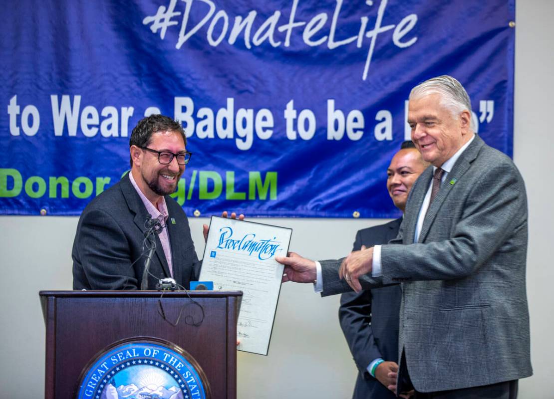 Clark County Commissioner Michael Naft, left, jokes with Gov. Steve Sisolak, right, Friday, Apr ...