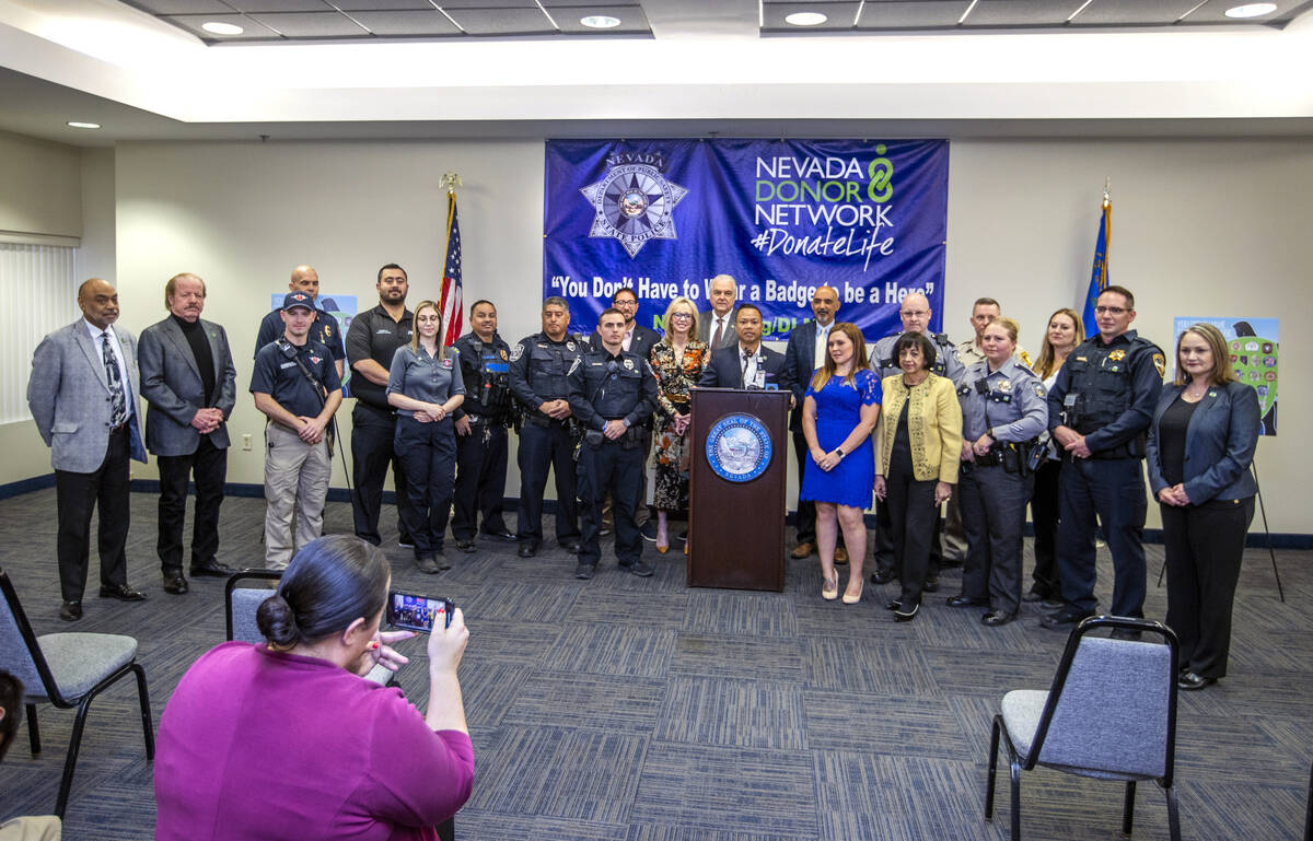 Gov. Steve Sisolak is joined by Clark County Commissioner Michael Naft and others following a p ...