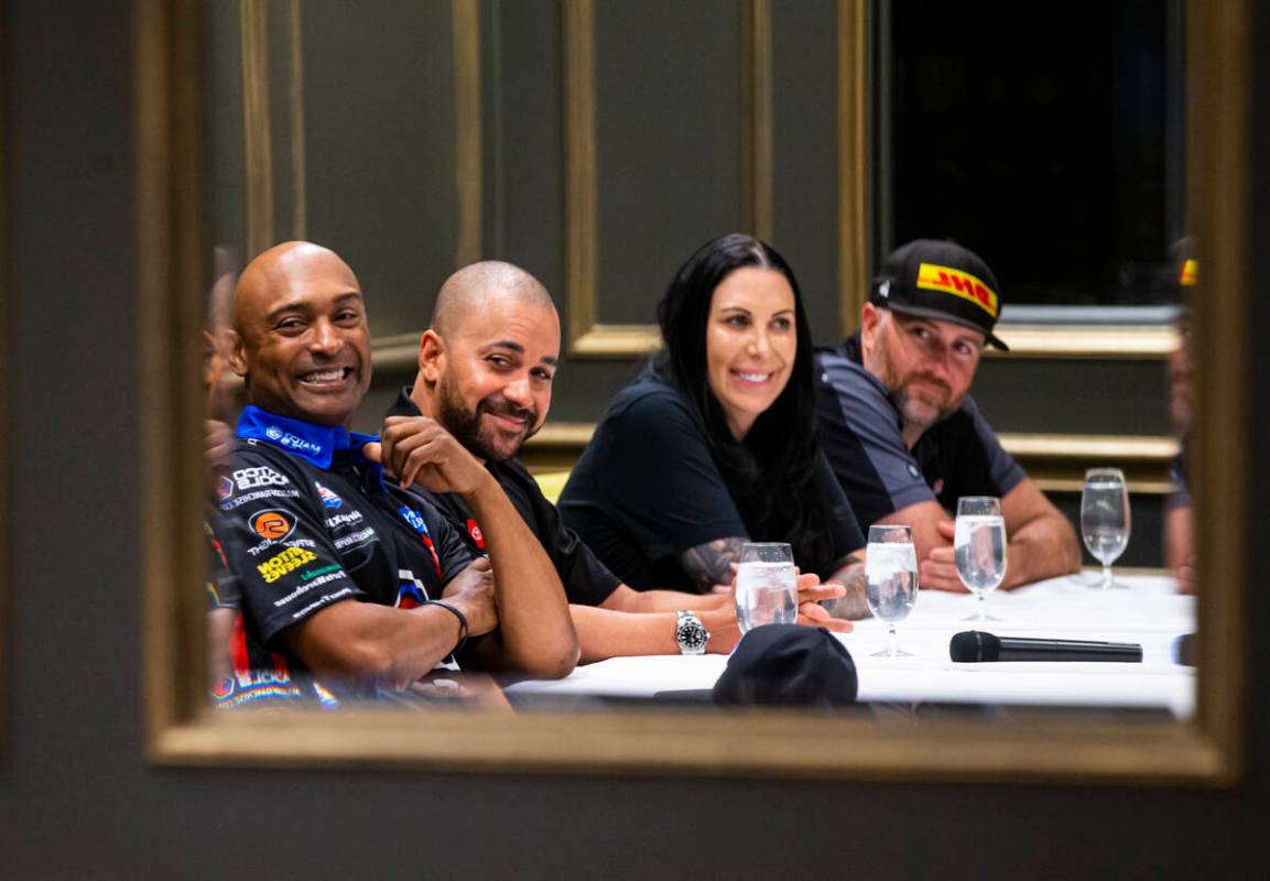 Drivers, from left, Antron Brown, J.R. Todd, Alexis DeJoria, and Shawn Langdon watch a commerci ...
