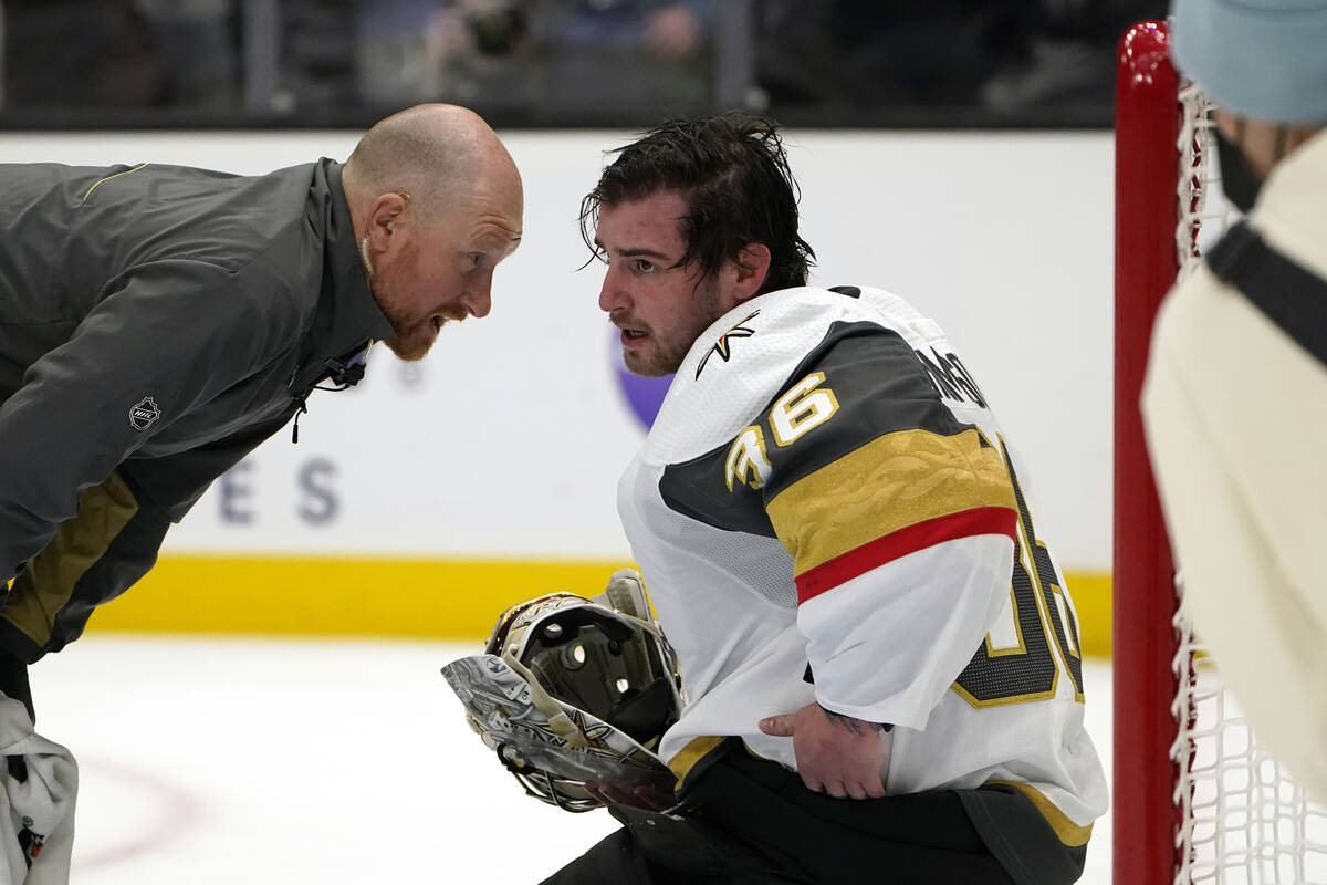 A trainer checks on Vegas Golden Knights goalie Logan Thompson during the second period of the ...