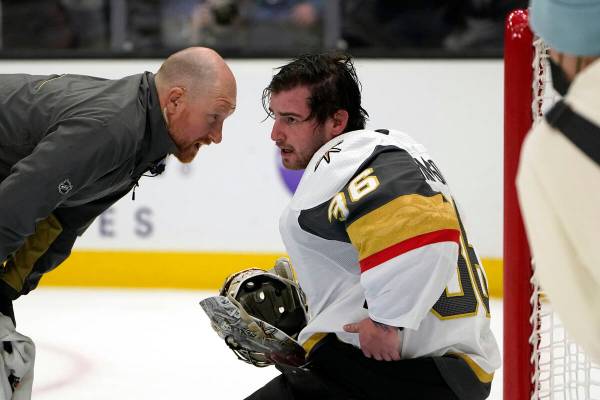 A trainer checks on Vegas Golden Knights goalie Logan Thompson during the second period of the ...