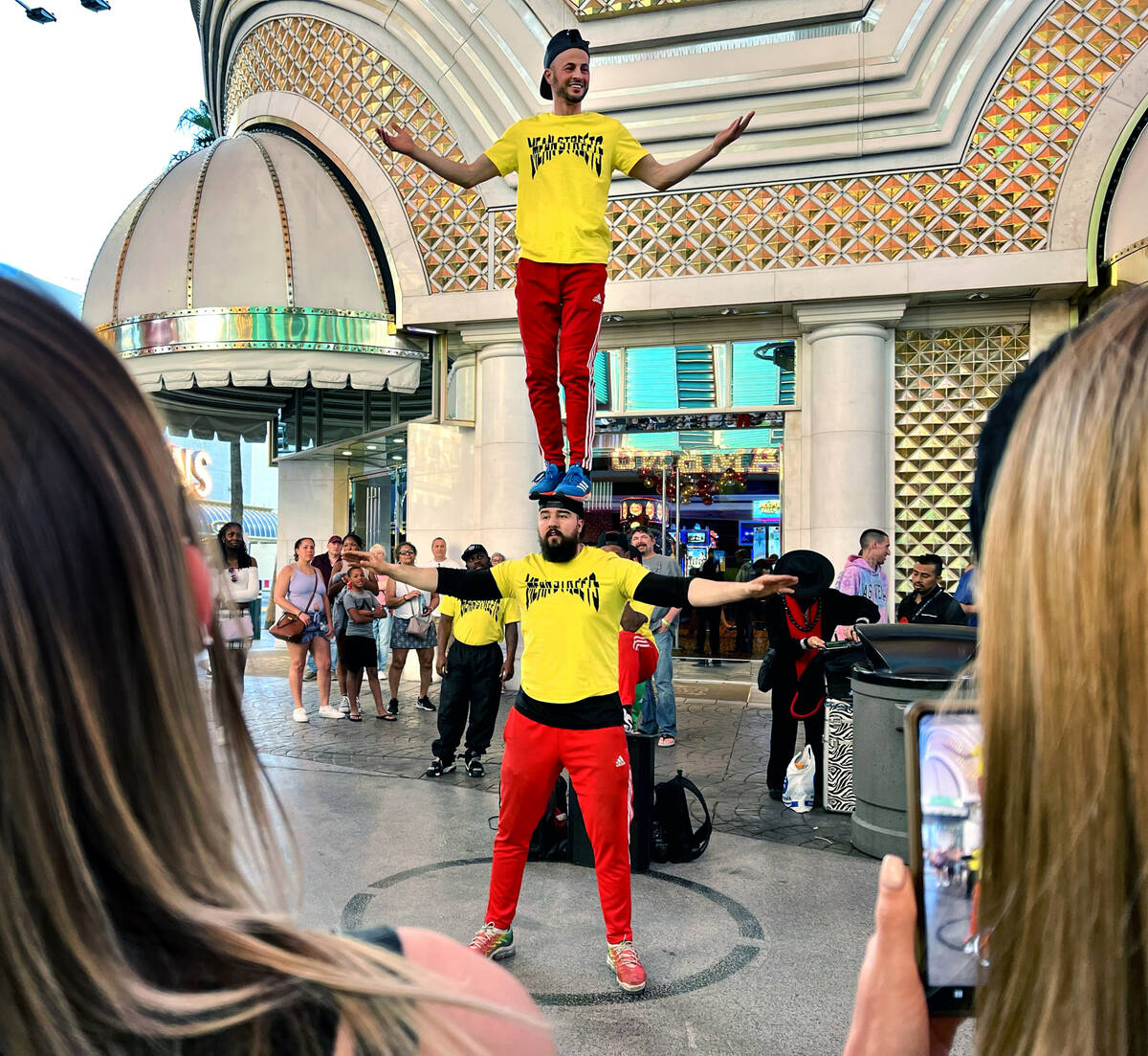 Street performers from dance group Meanstreets entertain the crowd from within their designated ...