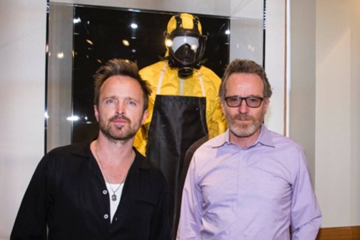 Aaron Paul, left, and Bryan Cranston pose in front of a "Breaking Bad" exhibit inside The Mob M ...