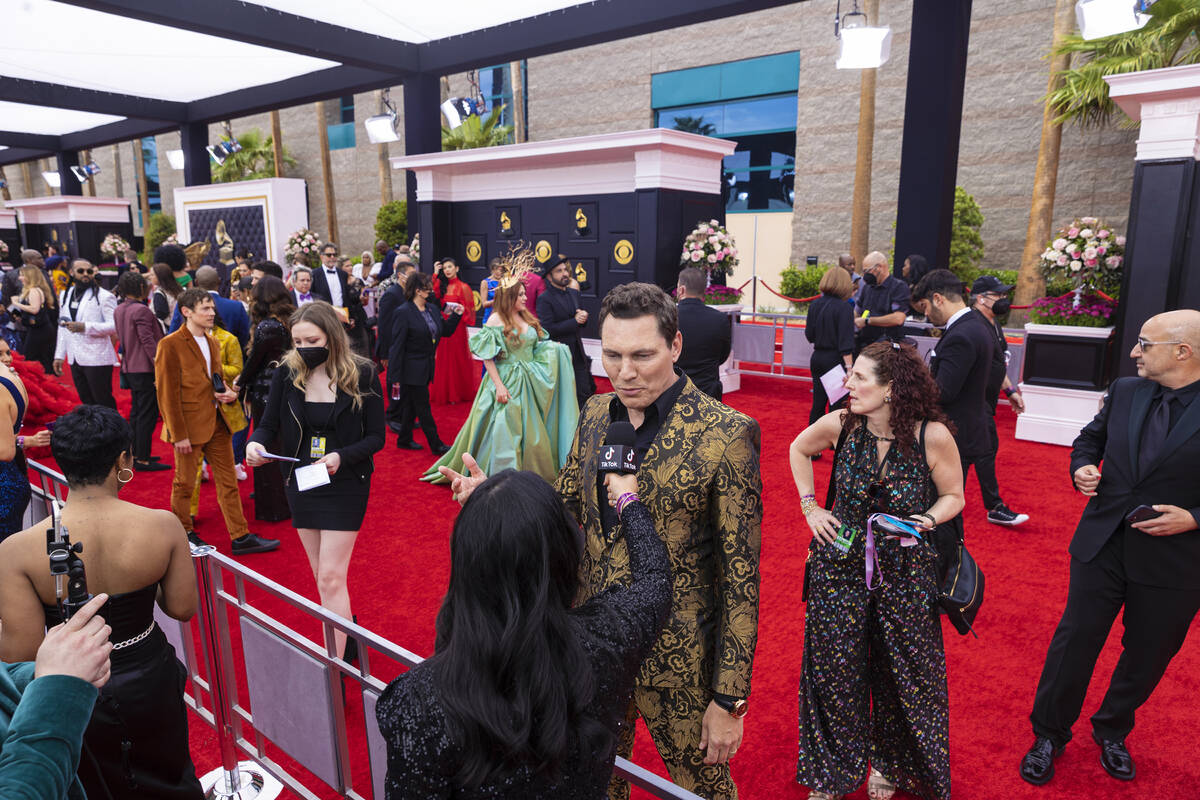 Tiësto (gold suit) on the red carpet before the start of the 2022 Grammy Awards on Sunday, Apr ...