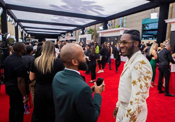 Leon Bridges, right, on the red carpet before the start of the 2022 Grammy Awards on Sunday, Ap ...
