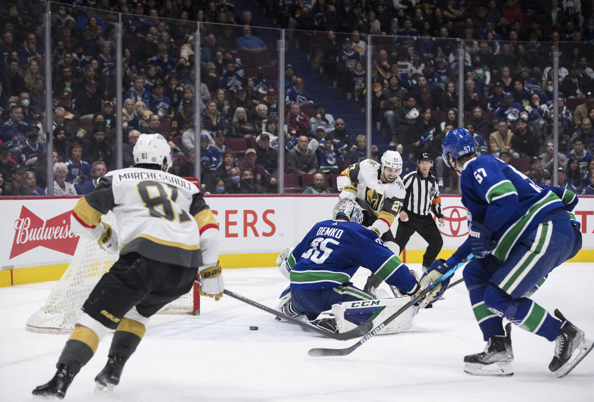 Vegas Golden Knights' Shea Theodore (27) scores against Vancouver Canucks goalie Thatcher Demko ...