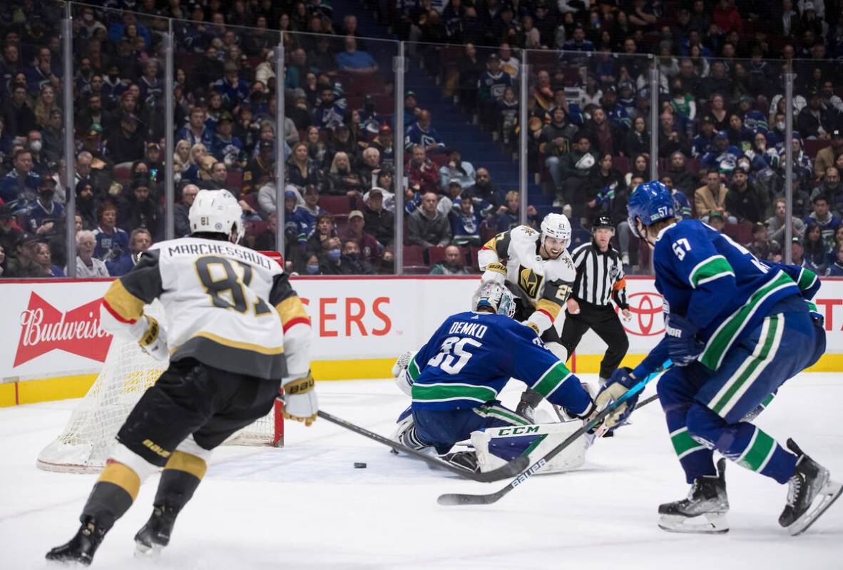 Vegas Golden Knights' Shea Theodore (27) scores against Vancouver Canucks goalie Thatcher Demko ...