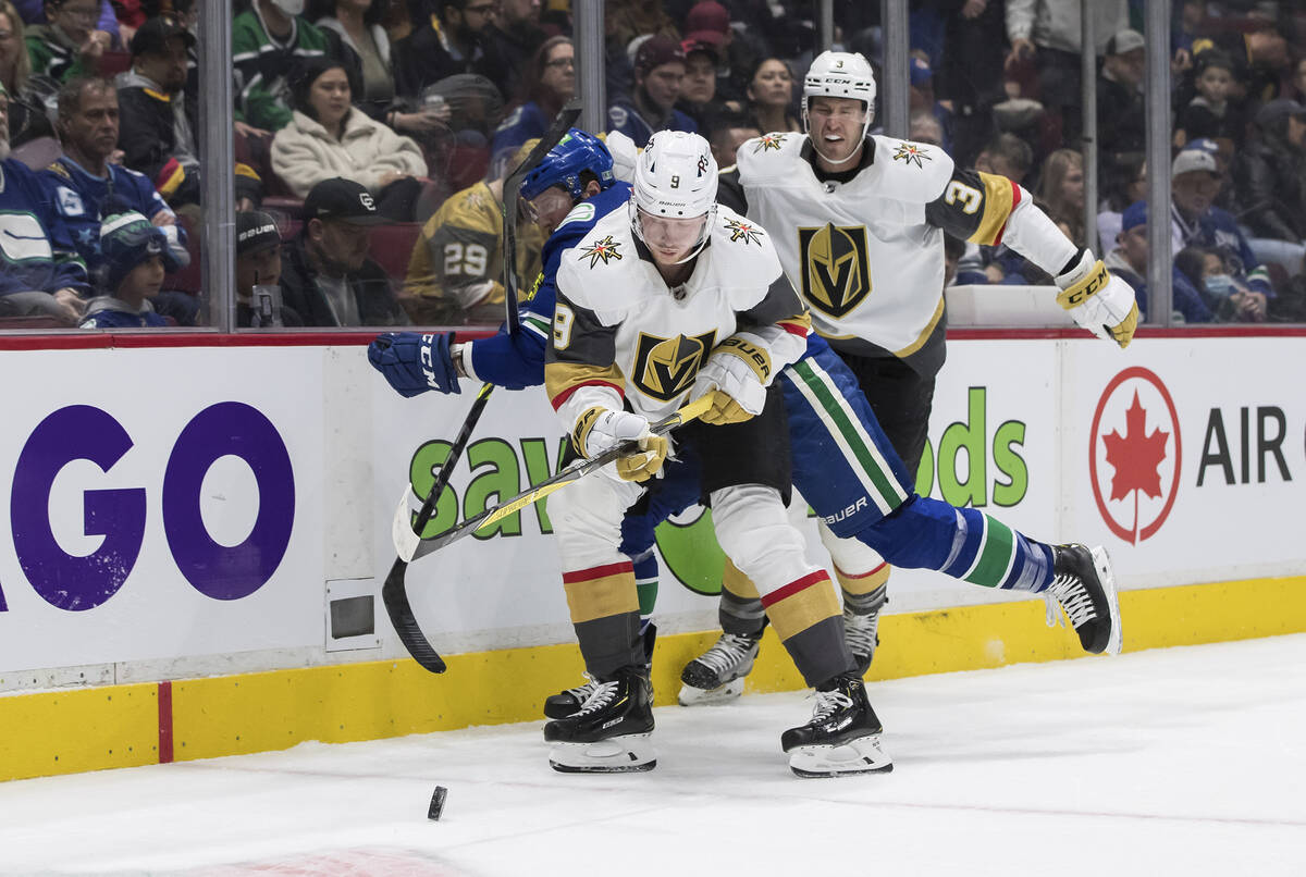 Vancouver Canucks' J.T. Miller, back left, vies for the puck against Vegas Golden Knights' Jack ...