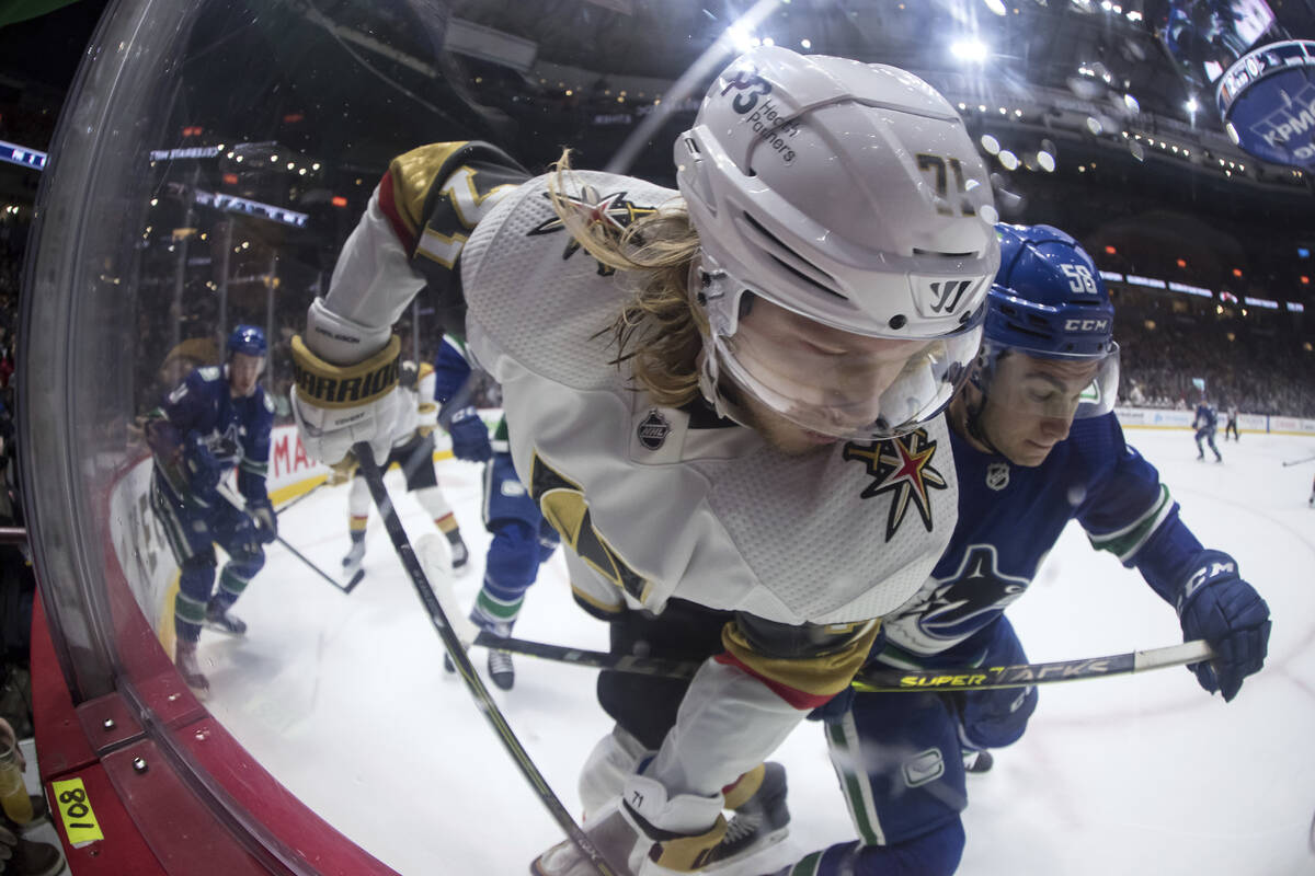 Vegas Golden Knights' William Karlsson (71), of Sweden, and Vancouver Canucks' William Lockwood ...