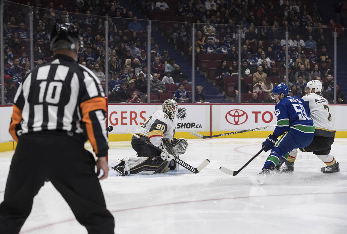 Vancouver Canucks' Bo Horvat (53) is stopped by Vegas Golden Knights goalie Robin Lehner (90), ...