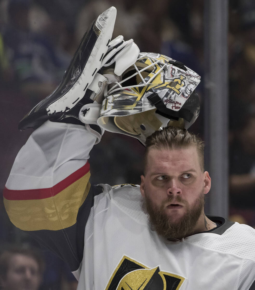 Vegas Golden Knights goalie Robin Lehner, of Sweden, puts on his mask before an NHL hockey game ...