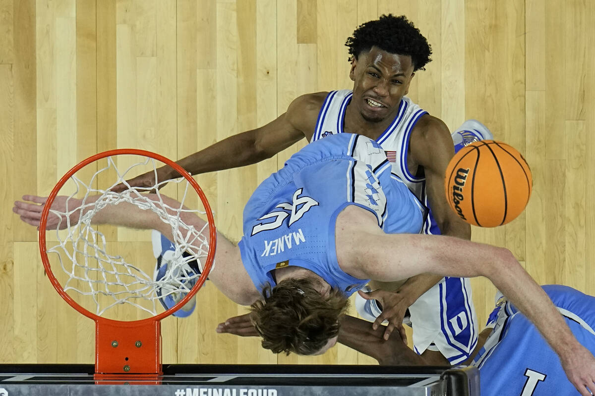 North Carolina forward Brady Manek (45) falls into Duke guard Jeremy Roach during the second ha ...