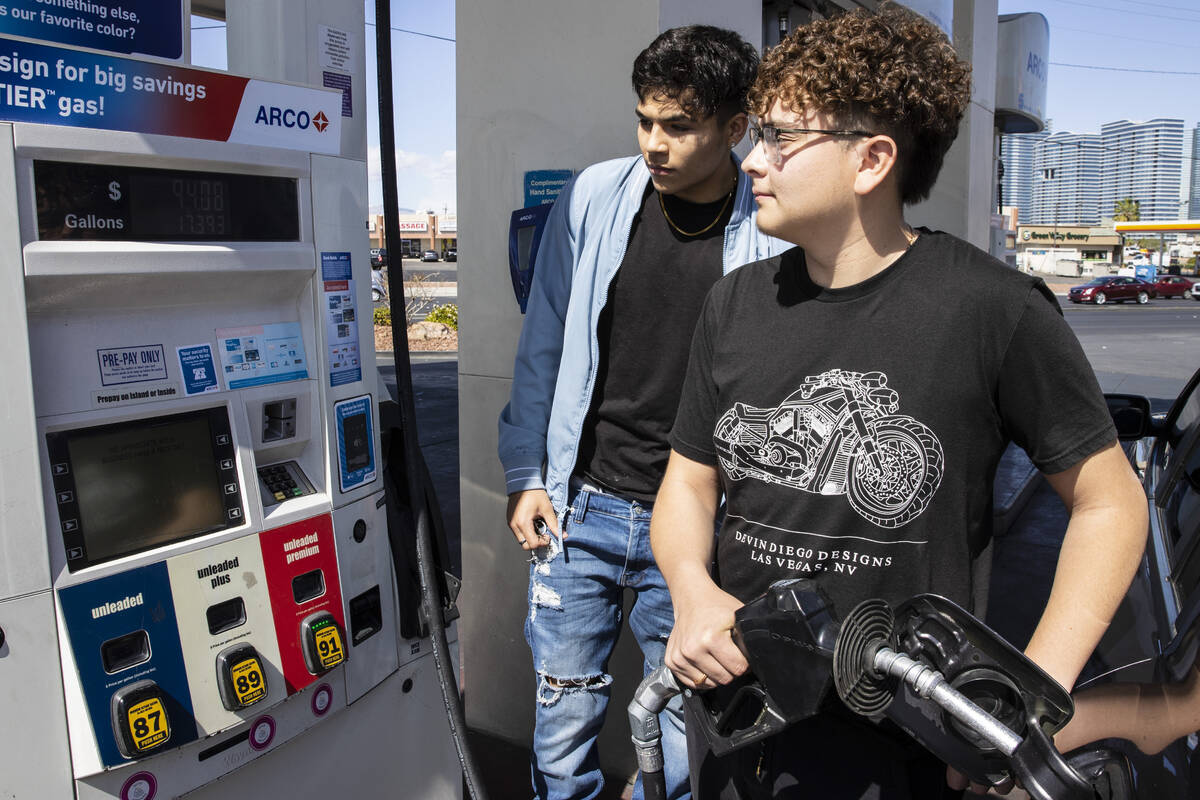 Gilberto Gonzalez, left, and his friend Naim Garcia, both of Las Vegas check out the price of g ...