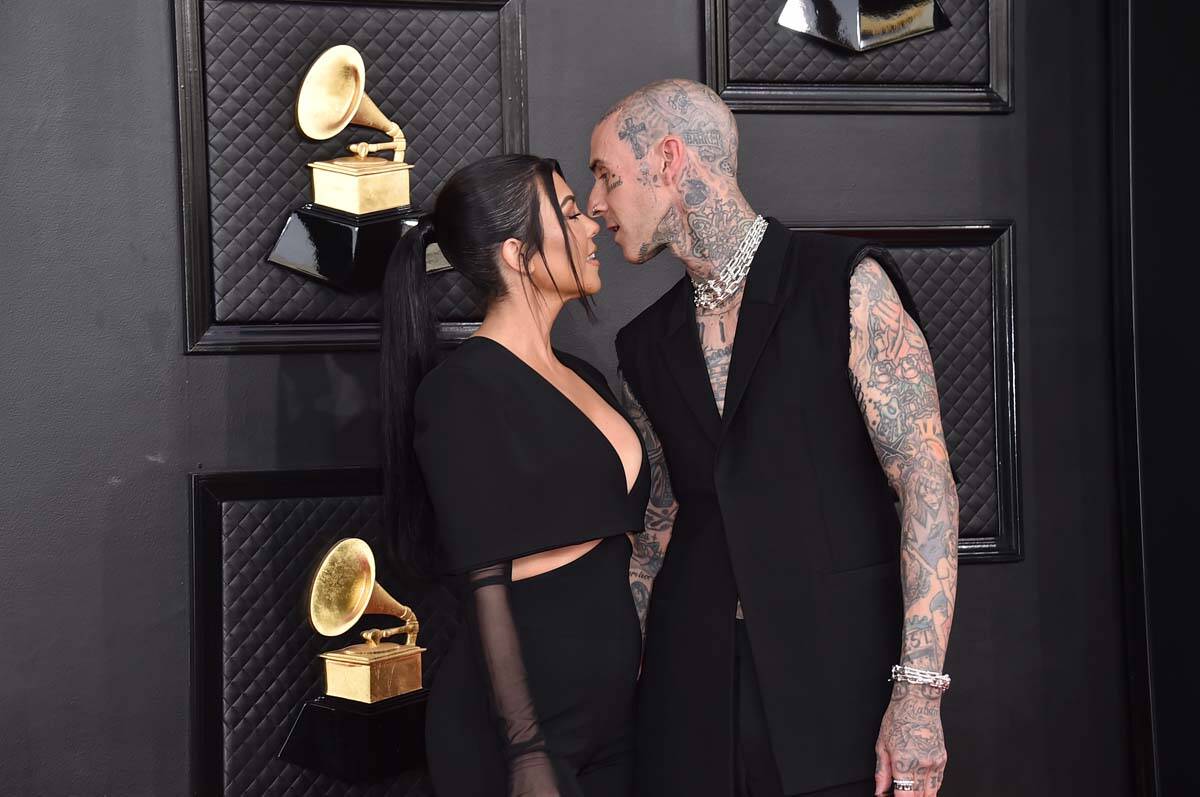 Kourtney Kardashian, left, and Travis Barker arrive at the 64th Annual Grammy Awards at the MGM ...