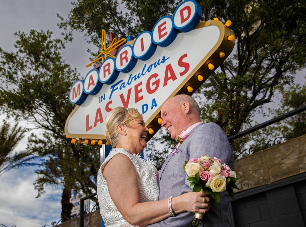 Paul and Linda Phillips, from Essex, England, pose for a photo in front of the wedding-inspired ...