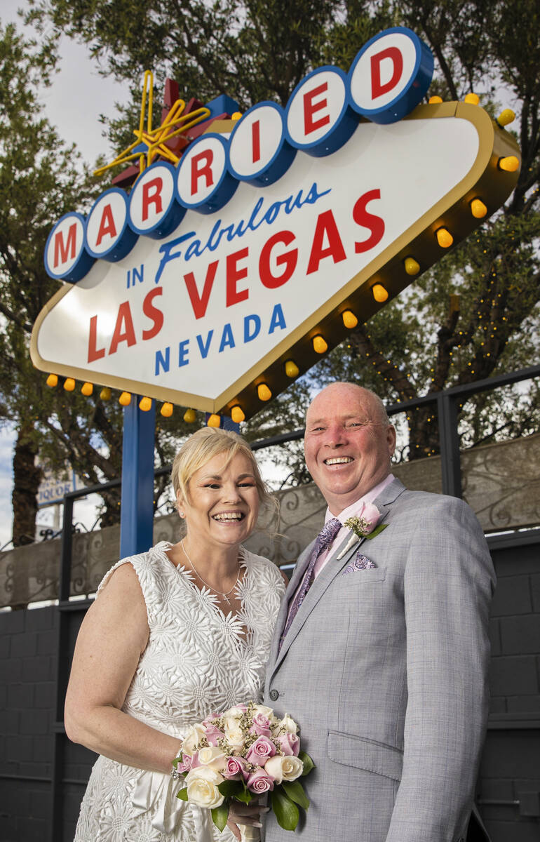 Paul and Linda Phillips, from Essex, England, pose for a photo in front of the wedding-inspired ...