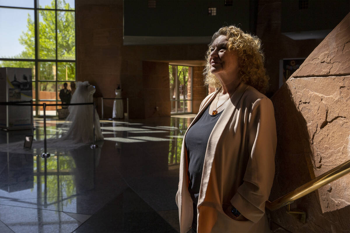 Clark County Clerk Lynn Goya poses for a portrait next to a historical wedding exhibit in the r ...