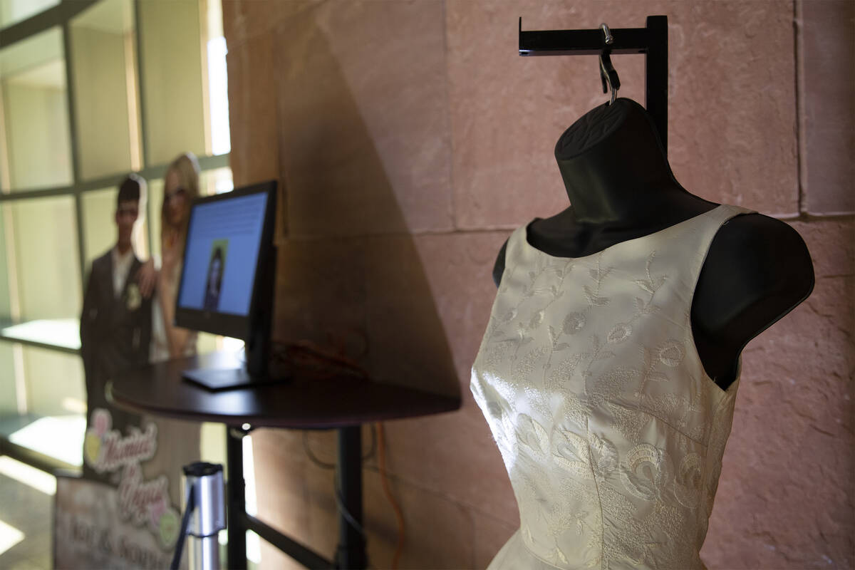 A vintage 1950s-style wedding dress is on display as part of a historical wedding exhibit in th ...