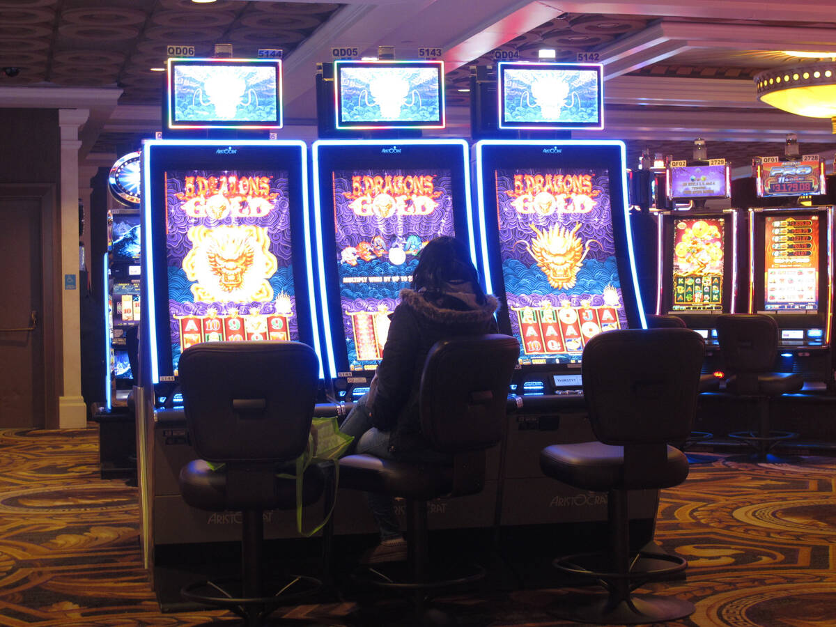 This Jan. 27, 2022, photo shows a gambler playing a slot machine at Caesars casino in Atlantic ...