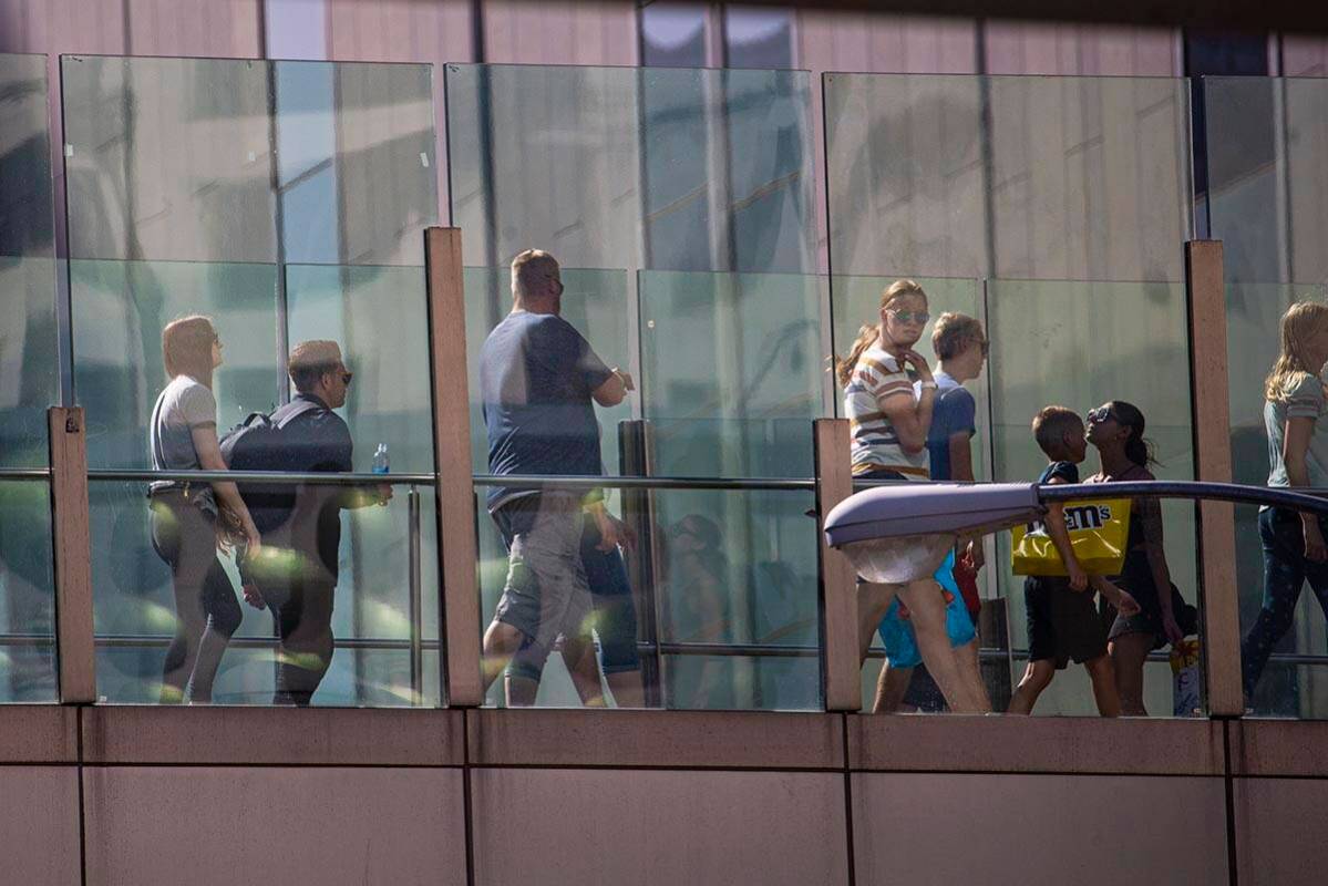 Pedestrians cross a bridge along the Las Vegas Strip on Wednesday, April 6, 2022, in Las Vegas. ...