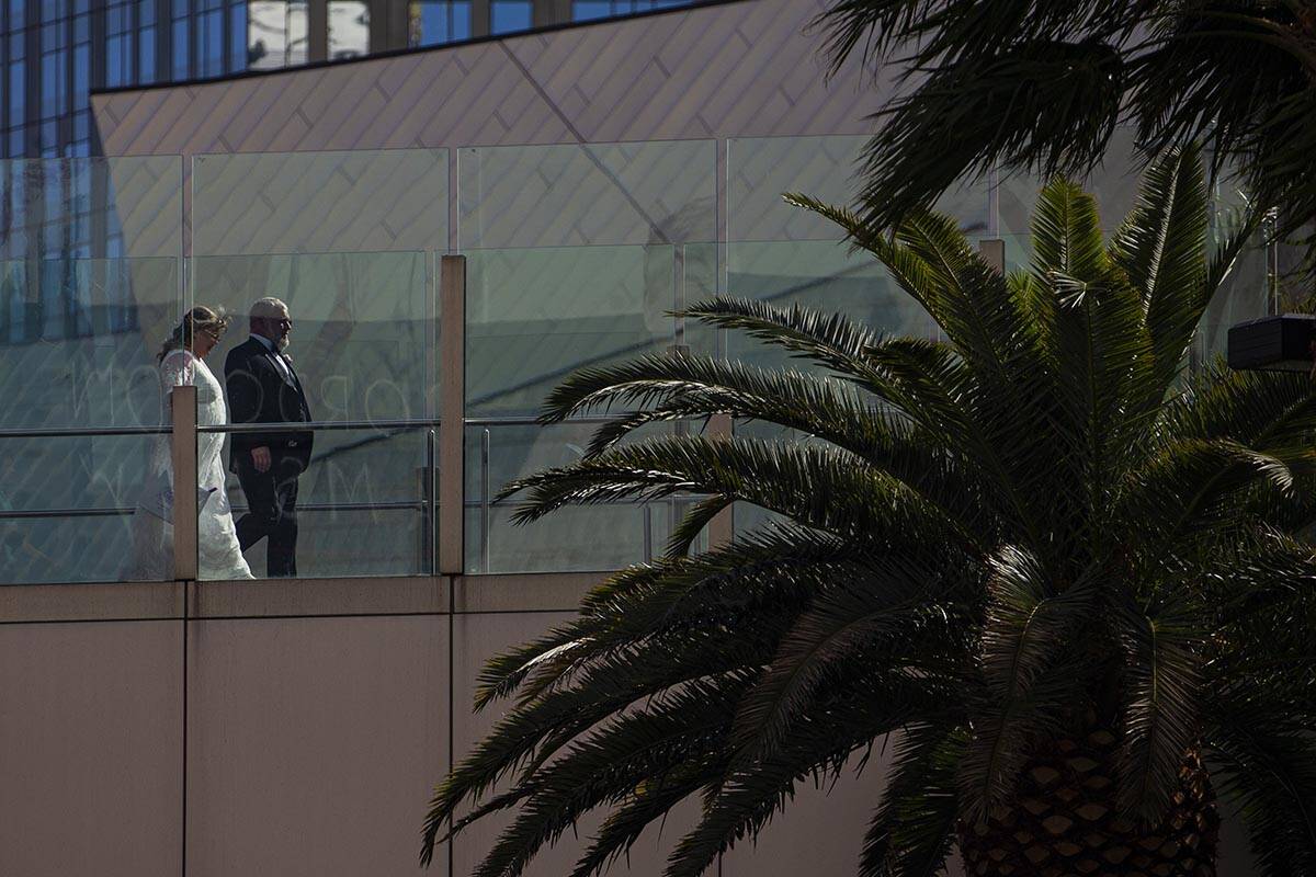 Pedestrians cross a bridge over the Las Vegas Strip on Wednesday, April 6, 2022, in Las Vegas. ...