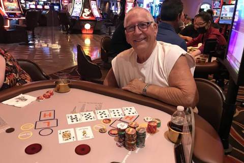Douglas with his winning Pai Gow progressive poker hand at Sunset Station Casino in Henderson o ...