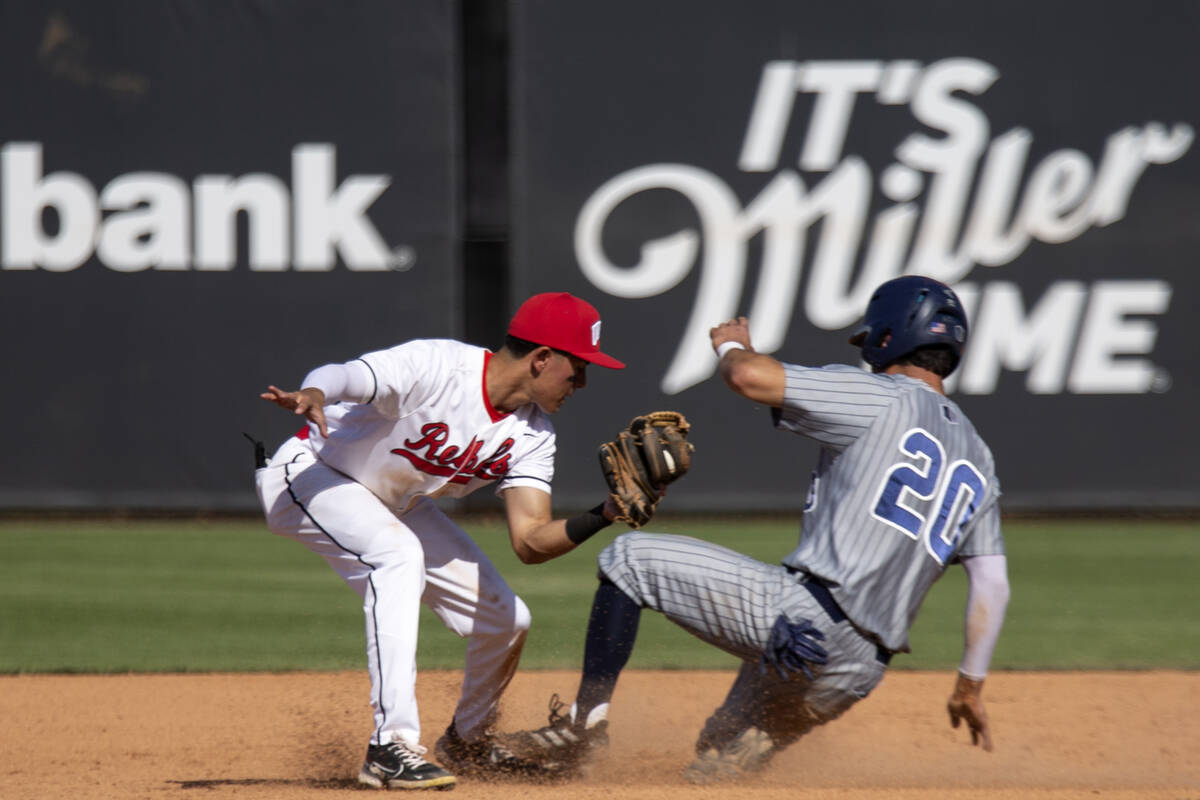 UNLV infielder Jordan Andrade (4) attempts an out at second base against UNR outfielder Anthony ...