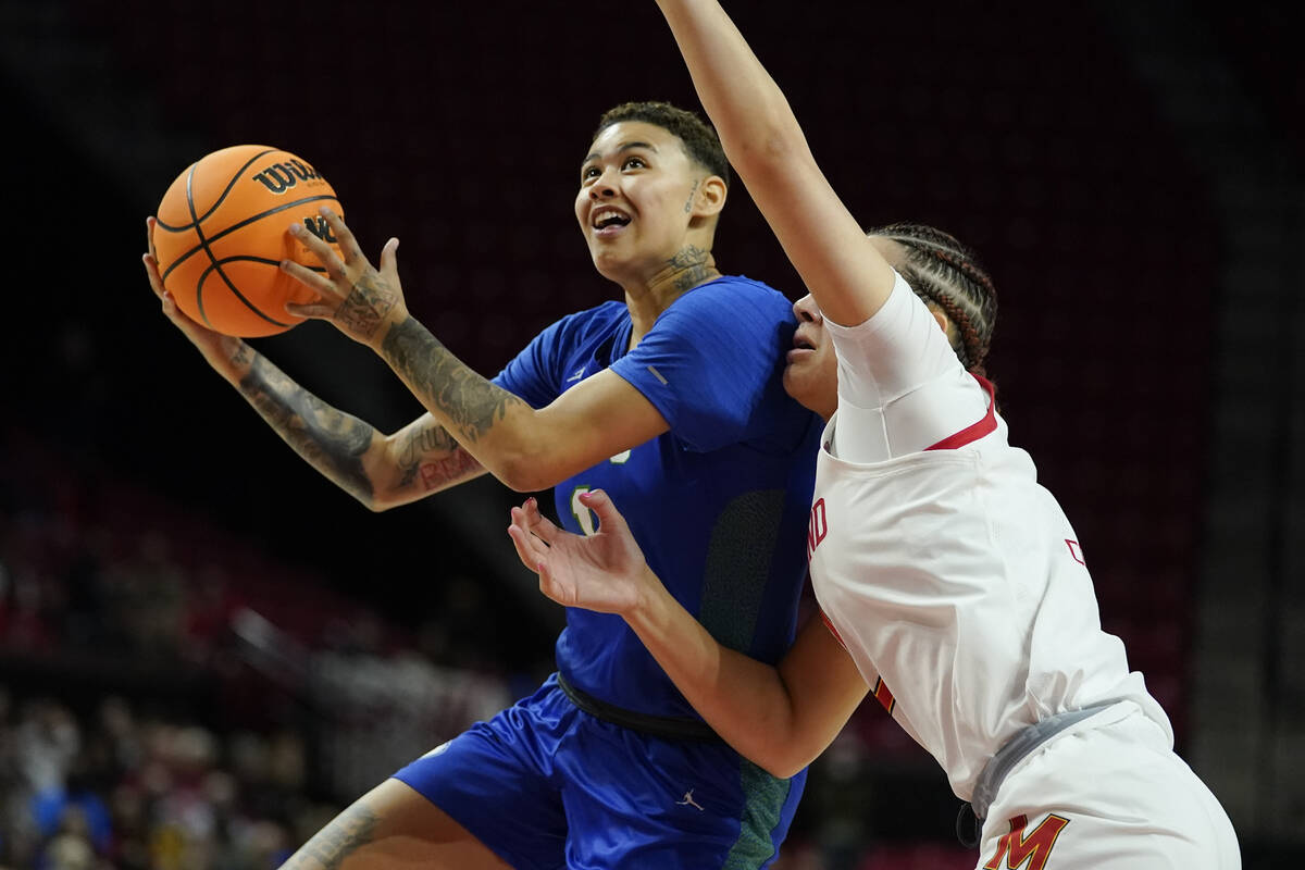 Florida Gulf Coast guard Kierstan Bell, left, goes up for a basket against Maryland forward Mim ...