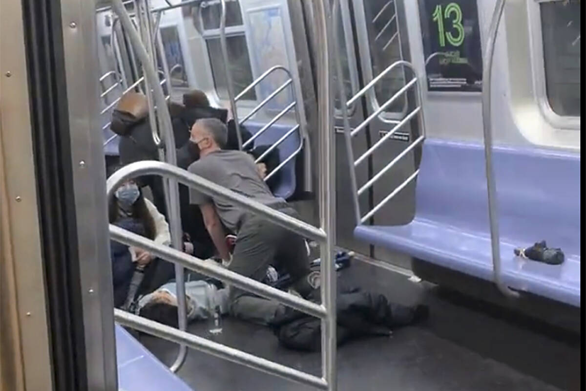 This photo provided by Will B Wylde, a person is aided in a subway car in the Brooklyn borough ...