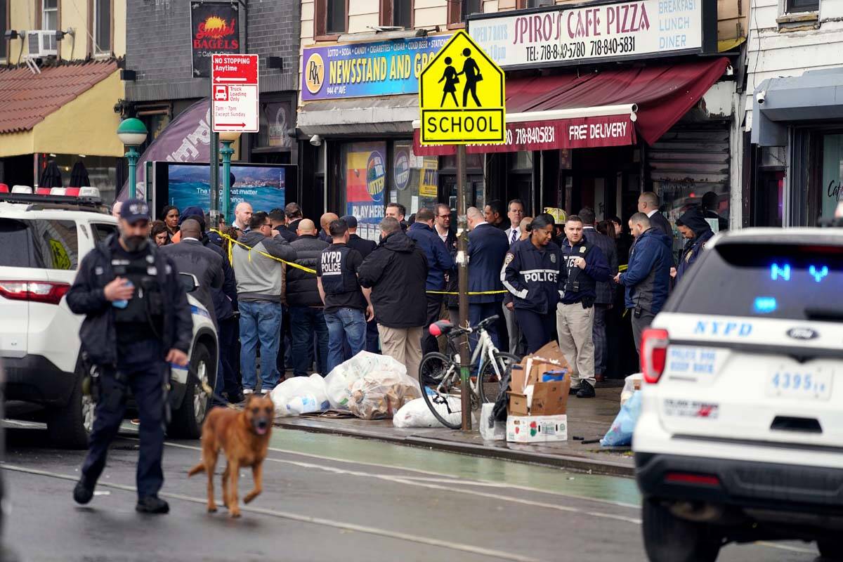 New York City Police Department personnel gather at the entrance to a subway stop in the Brookl ...