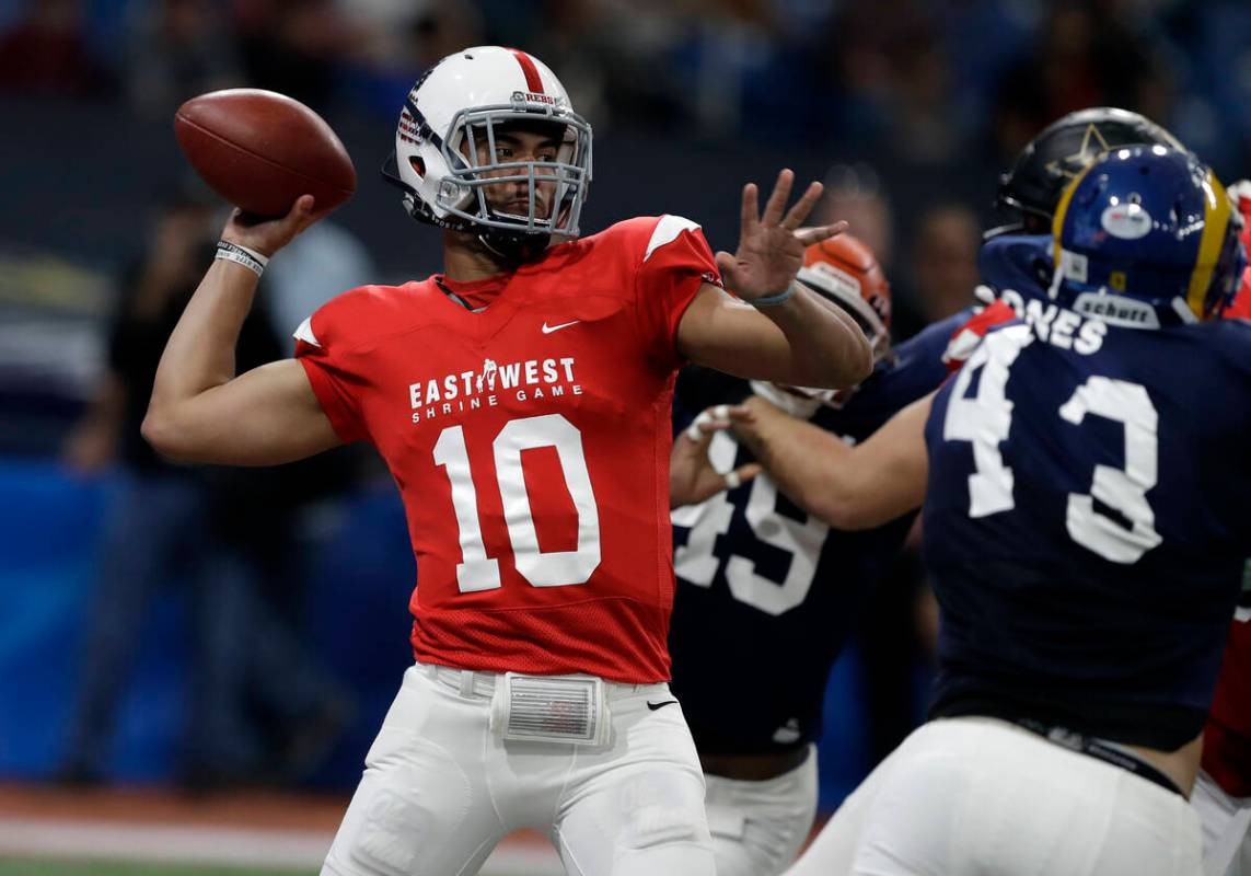 East quarterback Jordan Ta'amu (10), of Mississippi, throws a pass against the West during the ...