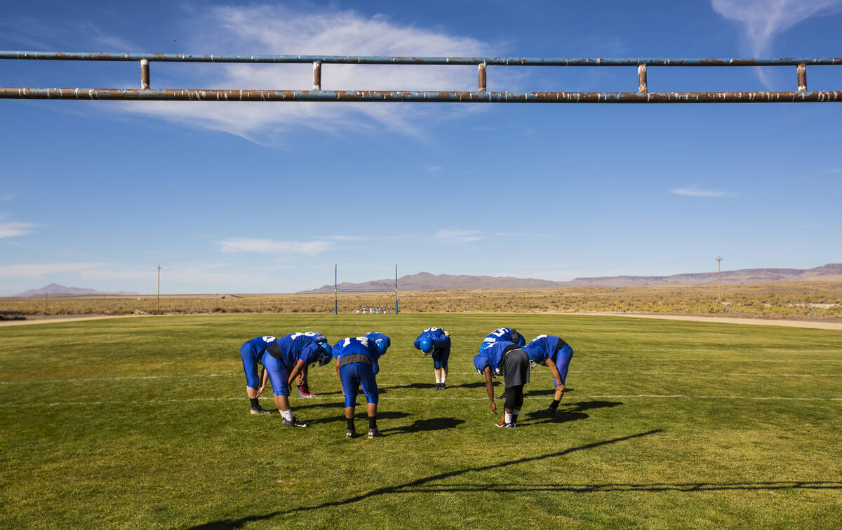 Football players stretch during practice at McDermitt High School in McDermitt in 2018. (Chase ...